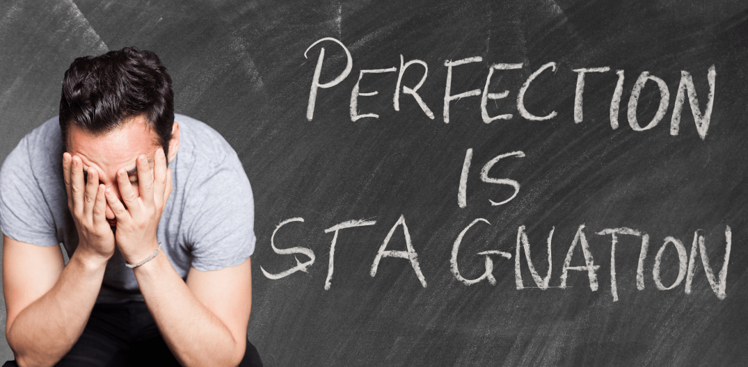Man with head in hands - Perfection is Stagnation