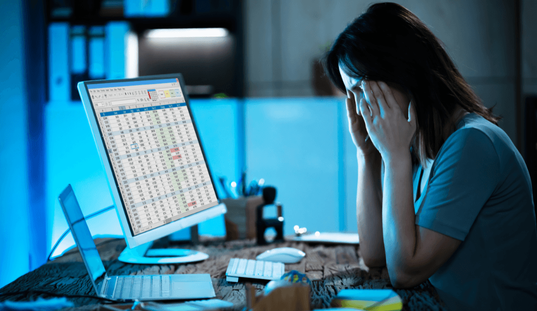 stressed woman working on spreadsheet