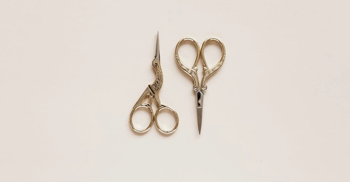 Top view composition of scissors of various shape with carved ornament on beige table