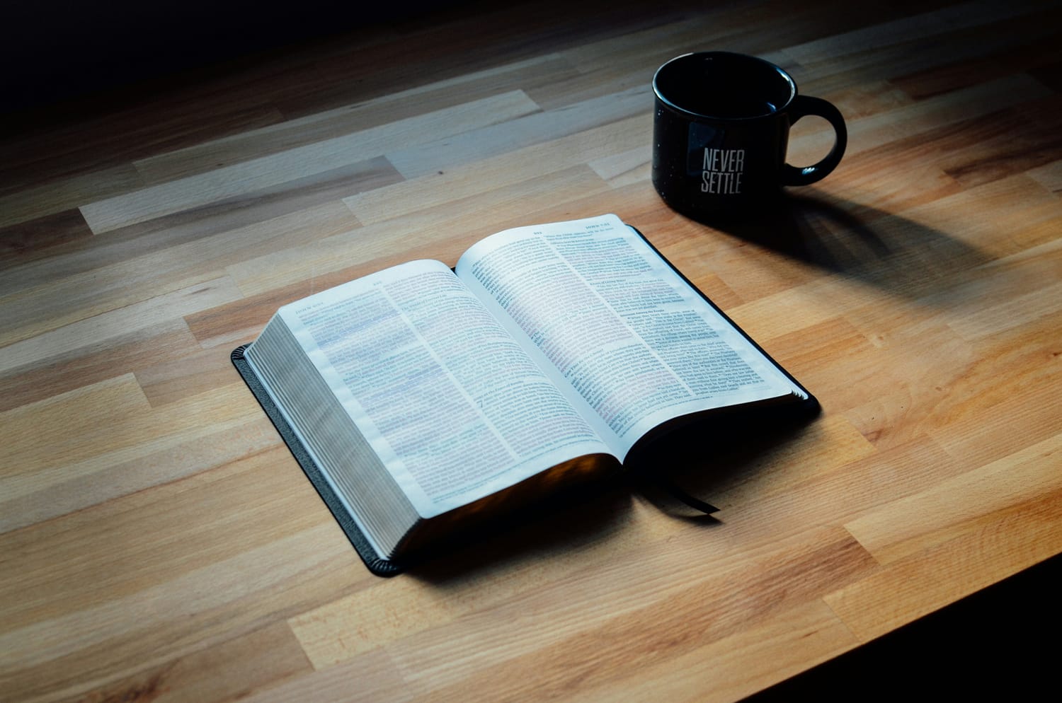 Bible and mug on table