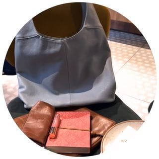 A stylish handbag and laptop on a café table - The Next Chapter category on Midlife in Italy blog