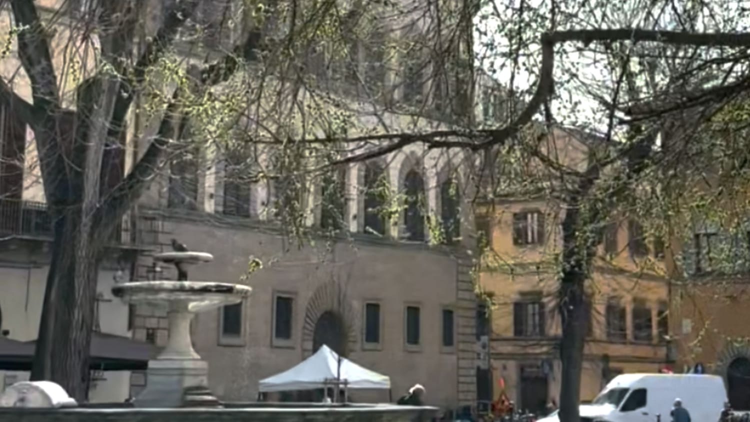 Piazza Santo Spirito with its trees just starting to shift in lovely spring green on a beautiful day in March