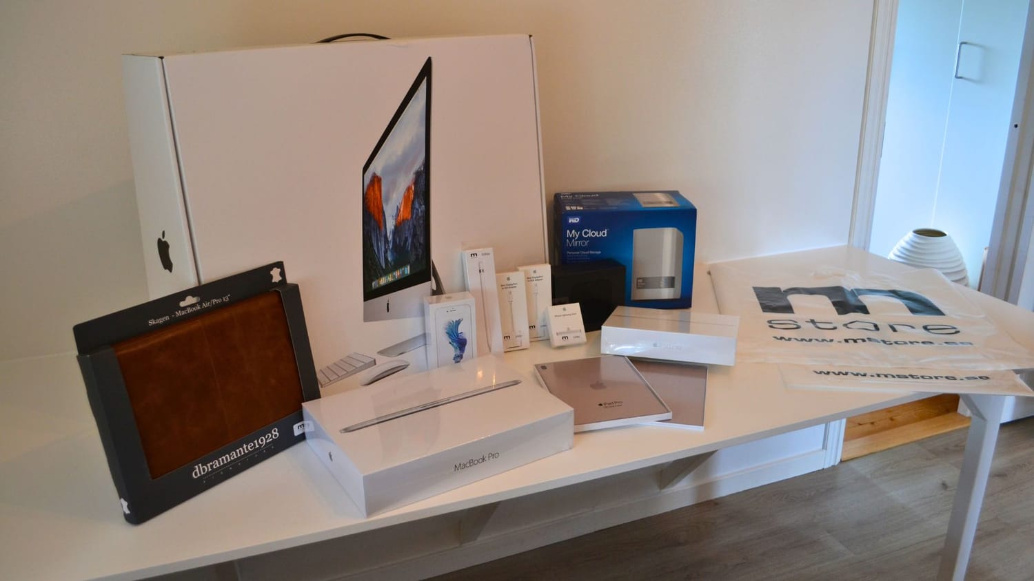 The LakeHouse Media web agency office setup in 2016, featuring a large iMac screen, heavy binders, paper calendars, and complicated tech equipment.