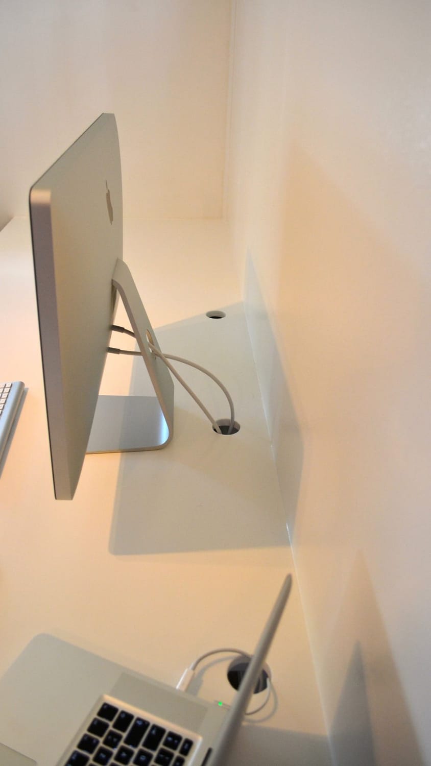 The LakeHouse Media web agency office setup in 2016, featuring a large iMac screen, heavy binders, paper calendars, and complicated tech equipment.