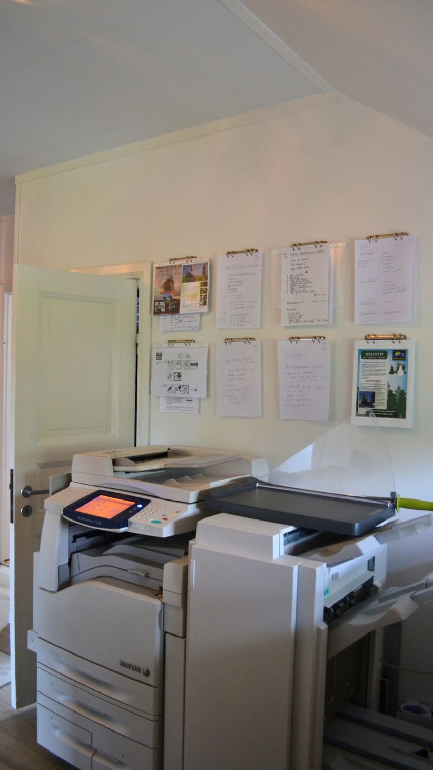 The big office printer. The LakeHouse Media web agency office setup in 2016, featuring a large iMac screen, heavy binders, paper calendars, and complicated tech equipment.