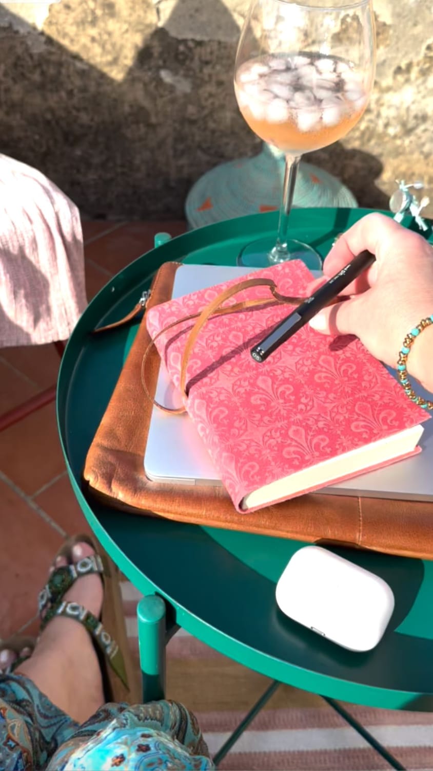 A pink notebook on a rooftop.