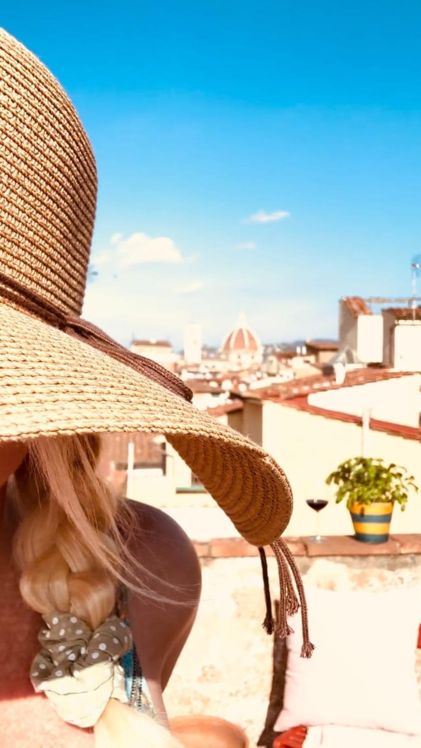 Pernilla in a sunhat on a sunny rooftop in Florence.