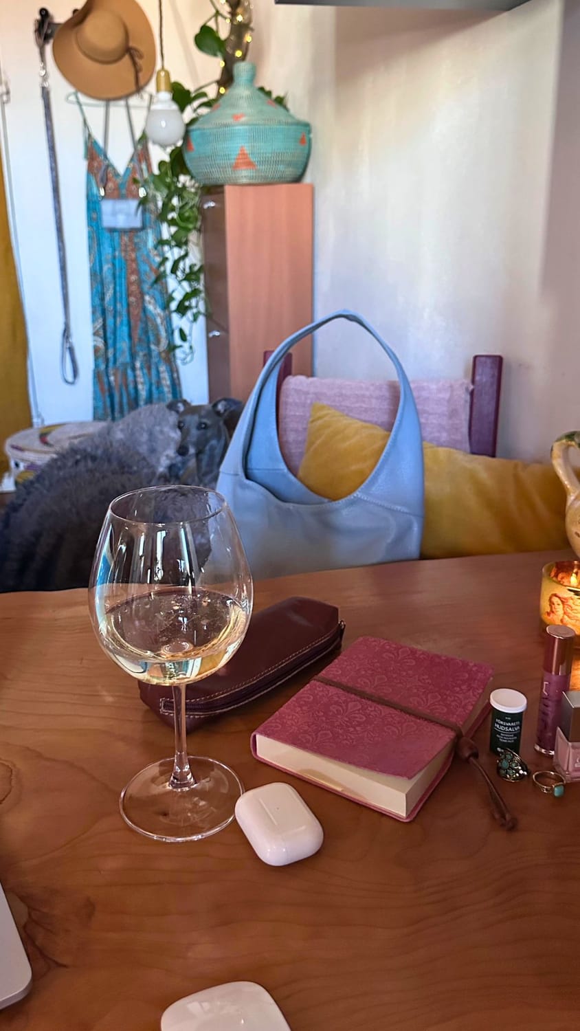 An Italian Greyhound dog named Sid resting next to a baby blue leather handbag, the symbol of a mobile online business in Italy.