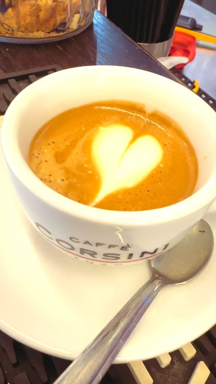 A caffè macchiato with a heart in the milk foam at Gusta Bar on Via Maggio in Florence.