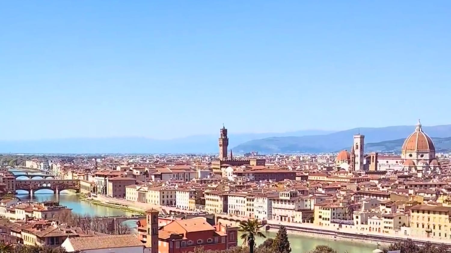 A sunny day spring view of Florence, Ponte Vecchio, Palazzo Vecchio and Il Duomo enjoyed from Piazzale Michelangelo.