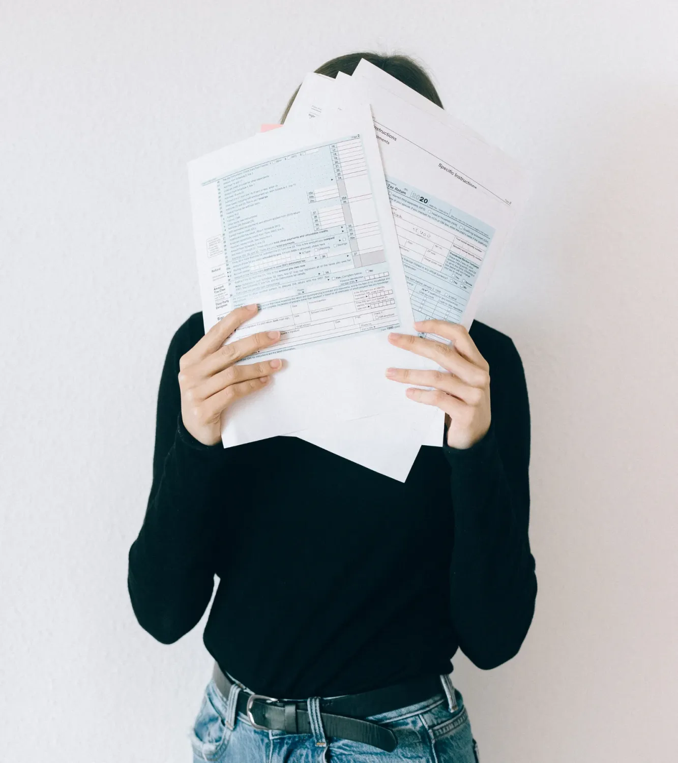 A business owner planning her week with notes and a laptop