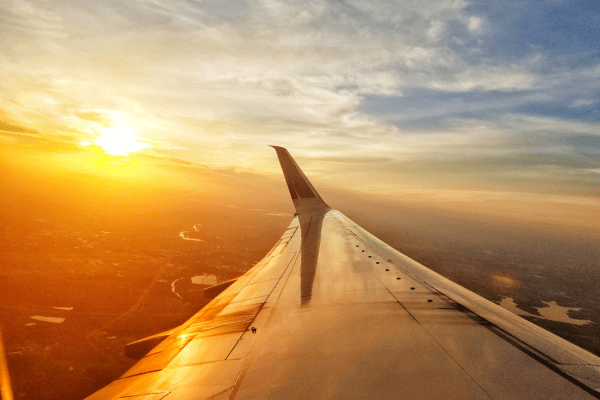 Why Boundaries Are Your Superpower in Recovering from Narcissistic Abuse - A view from the window of an aircraft looking over the wing to the sunrise
