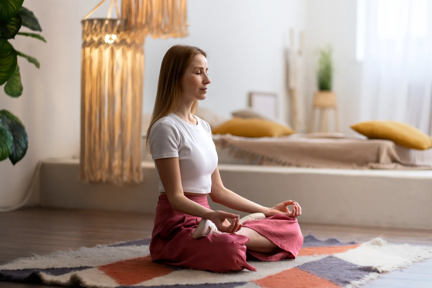 woman in a yoga top with arms crossed over chest grounding herself