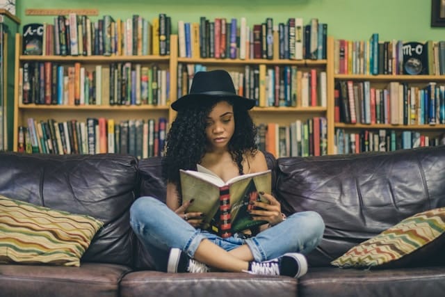 woman seated in library reading