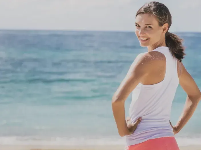 “Healthy woman in her 40s feeling strong and energized after gut healing”
