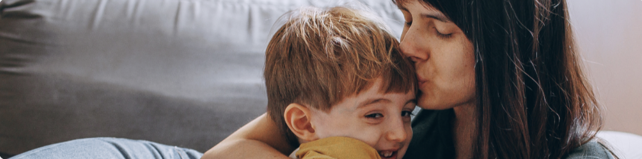mother kissing her boy child