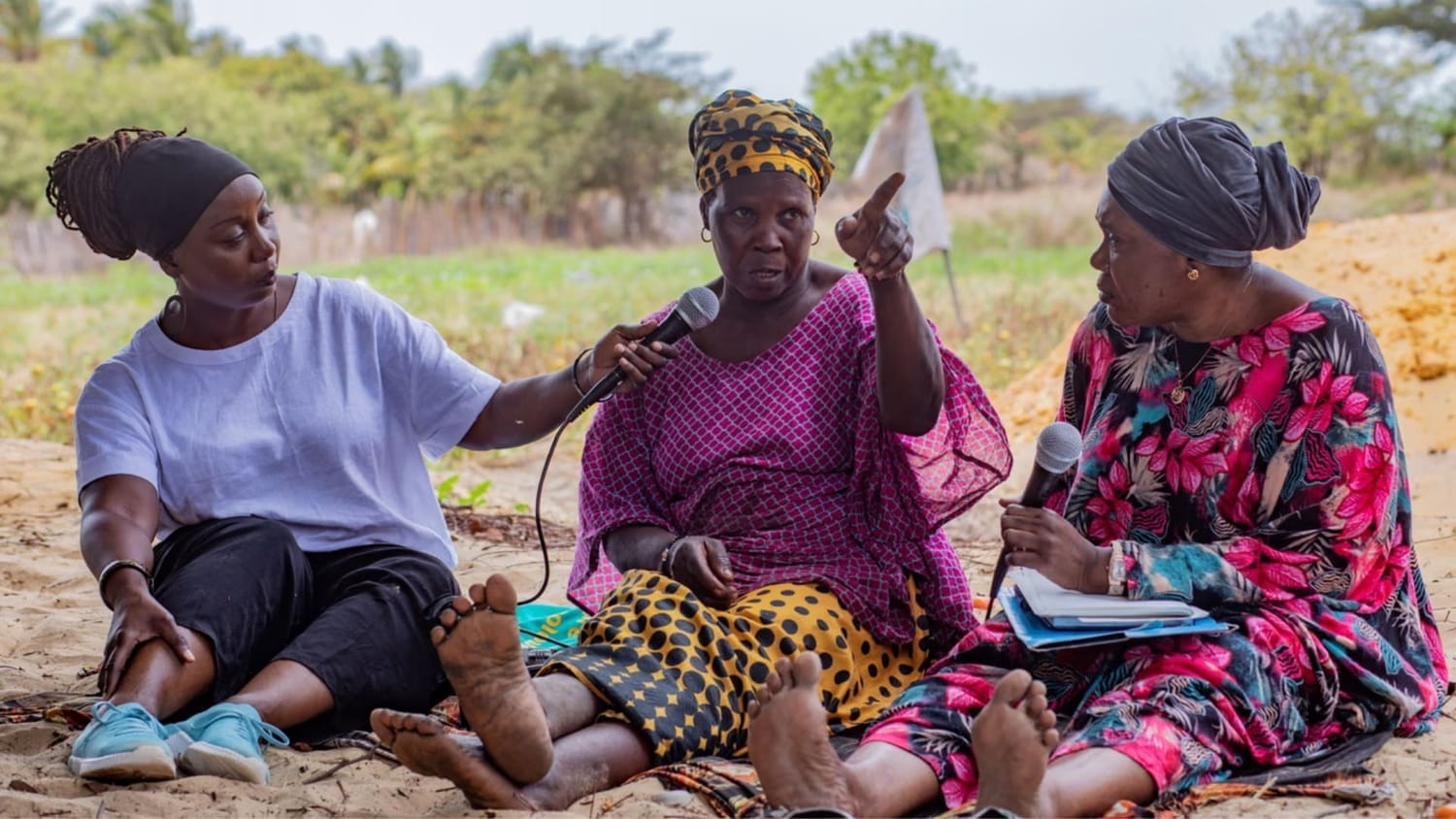 alt="Sylvia Arthur recording the thoughts and recollections of Fatou Jabang and Awa Senghore, in Kartong, in the south of the Gambia. Photograph: Sarjo Baldeh/AWOHOWA/National Geographic Society"