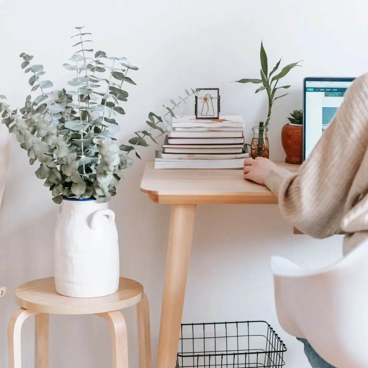 A serene, plant-filled workspace with a laptop, representing a focused environment for high-level business growth consulting.