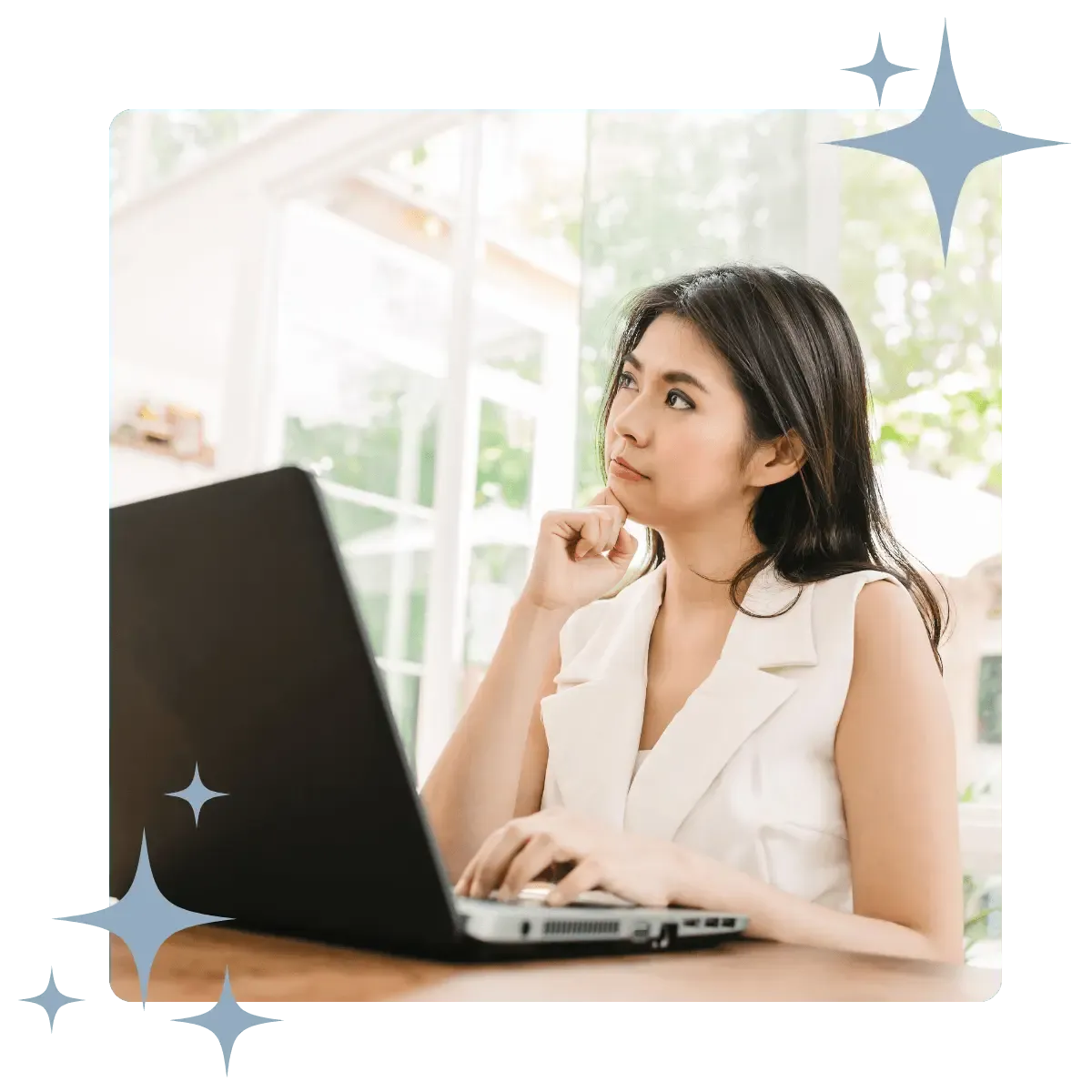 A professional woman thoughtfully working on a laptop, framed by decorative stars, symbolizing the focused effort in business growth consulting.