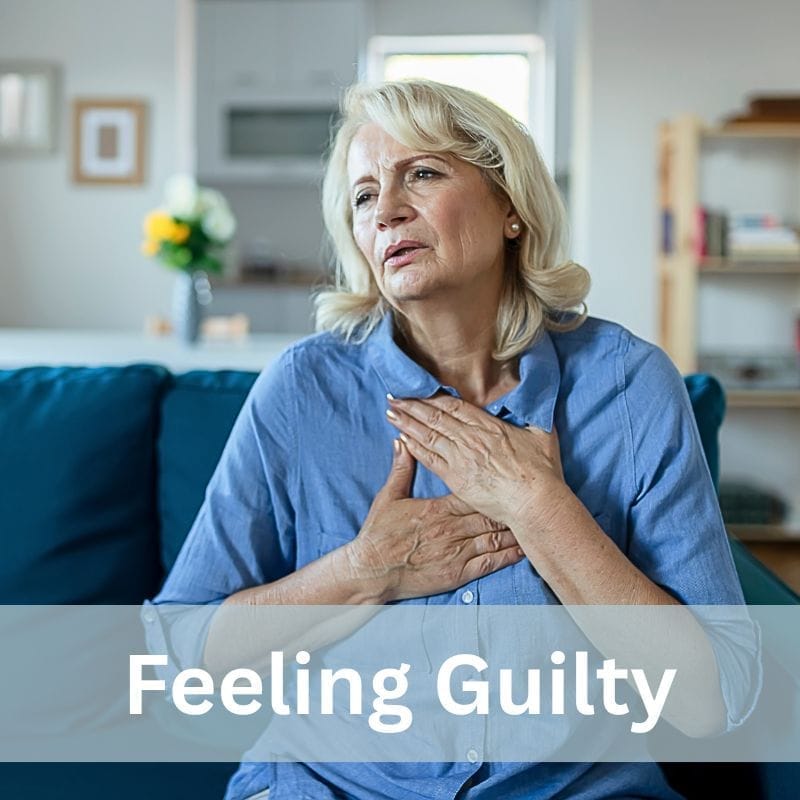 Midlife woman holding her hands on her chest: feeling guilty