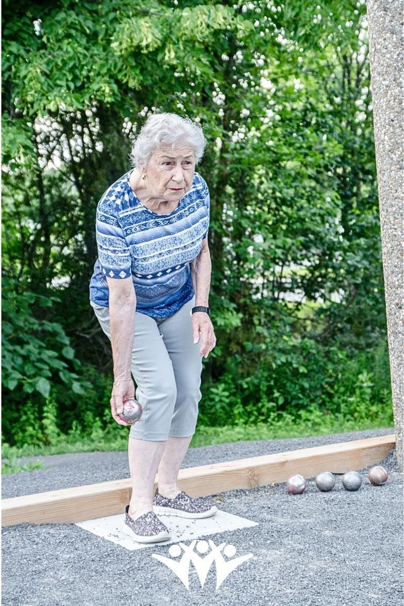 Building friendhips by starting low-pressure settings - older woman playing ball game outside