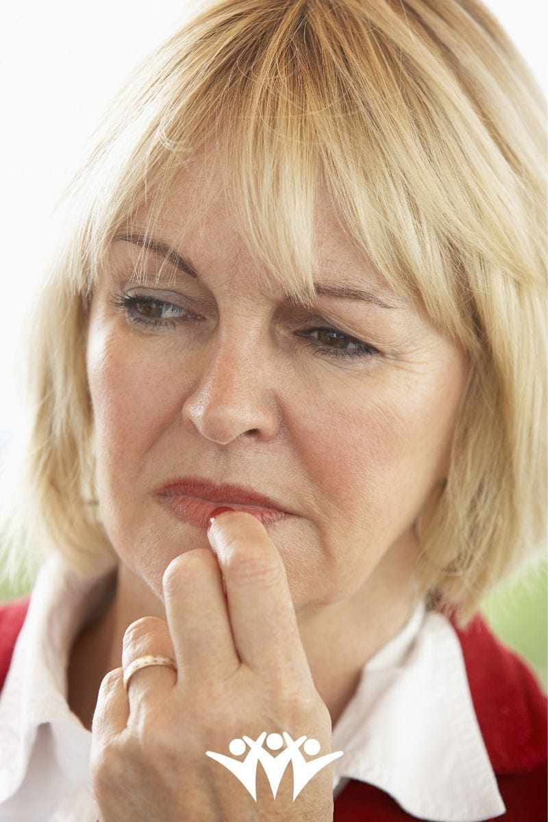 Woman looking hesitant - be open about nerves to build new friendships is ok.