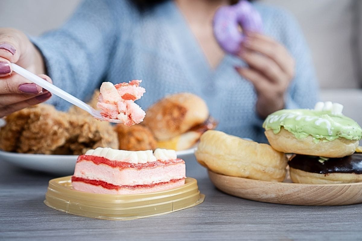 A woman tucking into a slice of cake