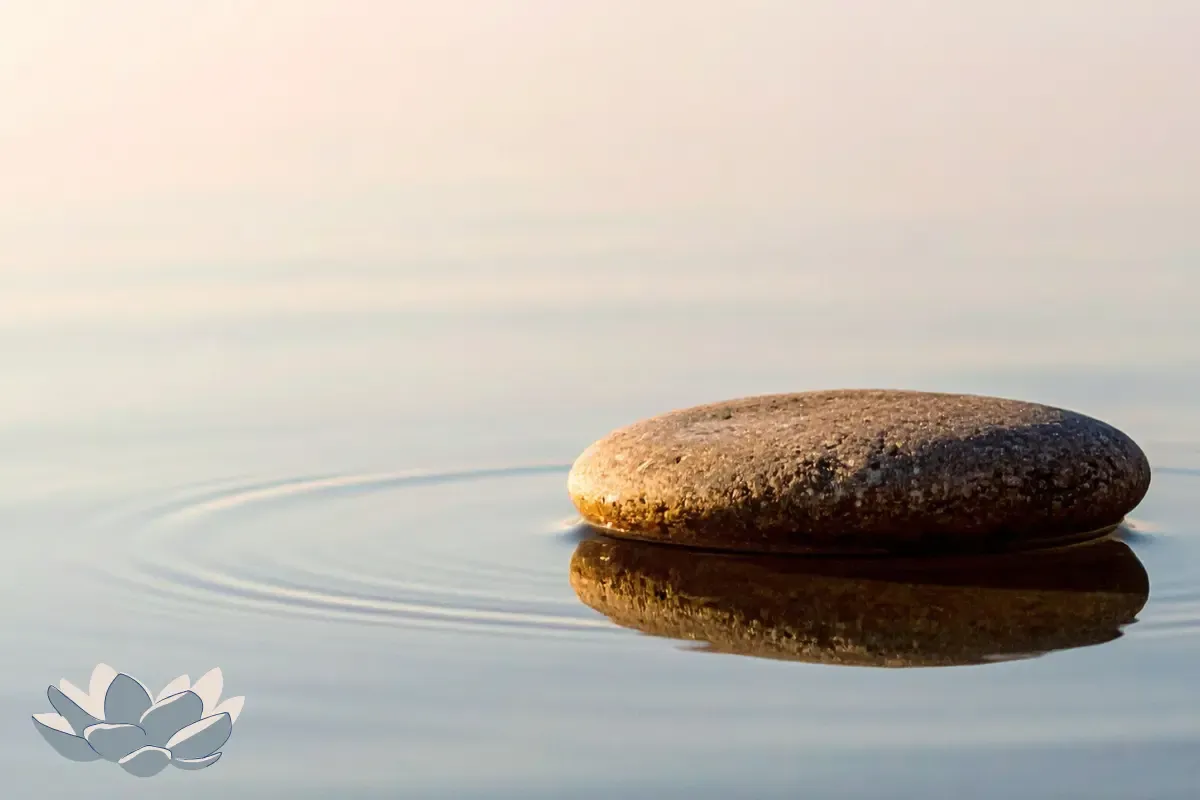 Serene stone in calm water representing emotional balance and food freedom for women over 50
