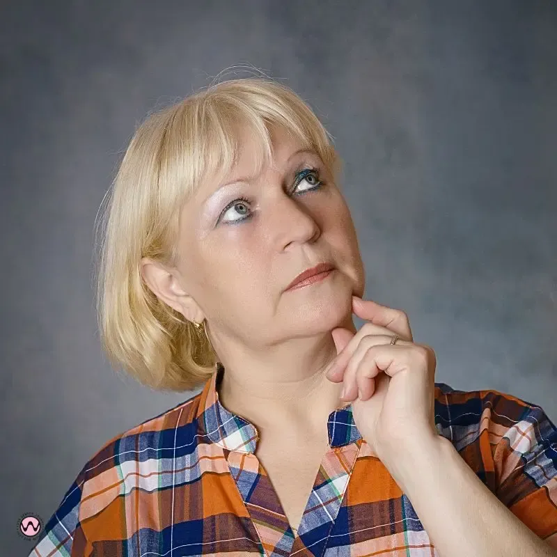 factors)	A thoughtful woman considering lifestyle factors like stress and age that negatively impact Vagus nerve health and emotional well-being.