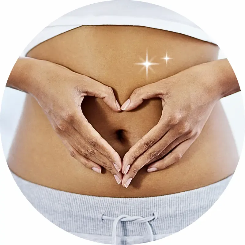 A mature woman holding her hands in a heart shape over her stomach, symbolising the connection between gut health and emotional well-being for women over 50.