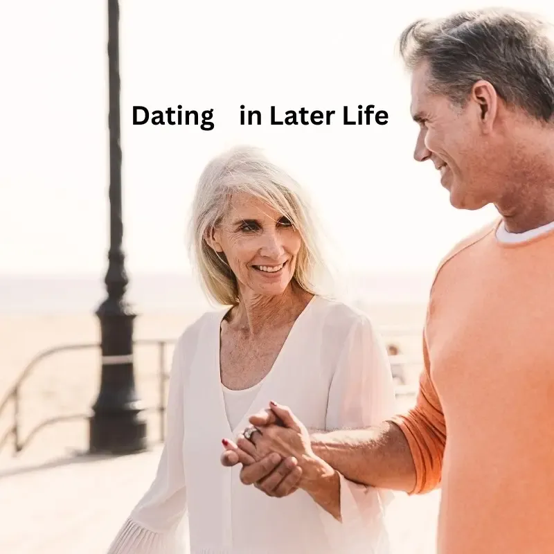 A woman smiling at her date while holding hands, reflecting new romantic relationships after 50