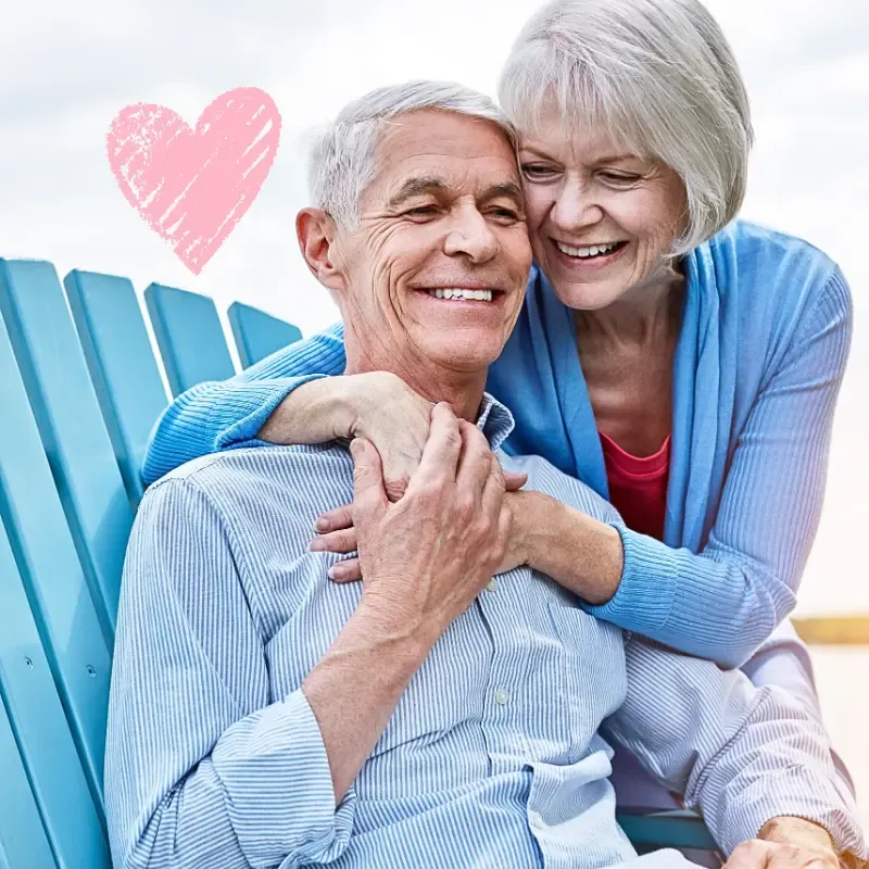 Happy older couple sharing an intimate romantic moment outdoors, reflecting healthy relationships after 50