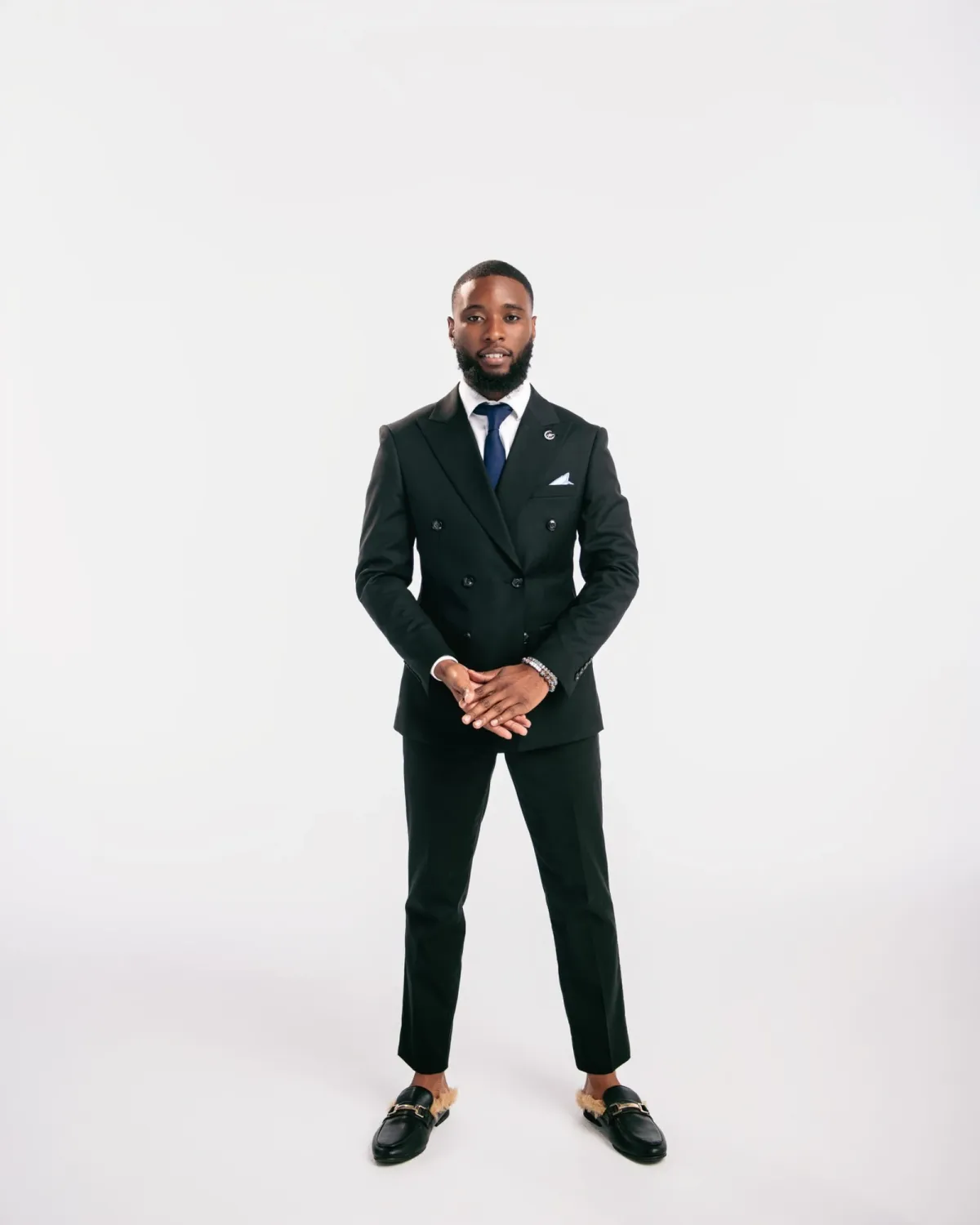 Eddie Bazile standing in a black suit