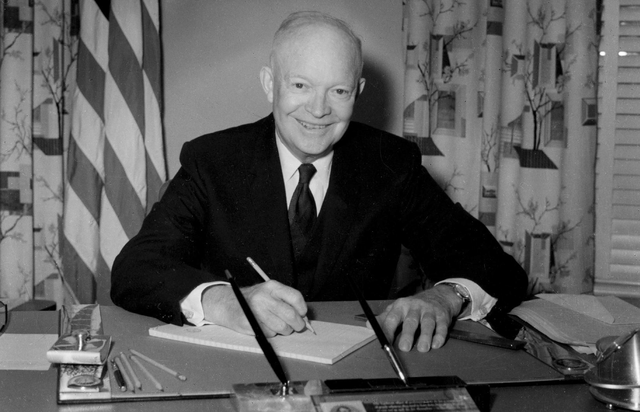 Archival photo of Eisenhower at desk.