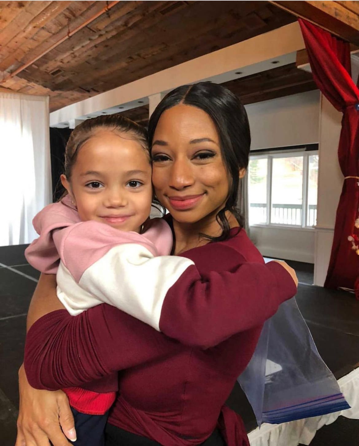 Vanessa Fox smiling with Monique Coleman behind the scenes of Christmas Dance Reunion