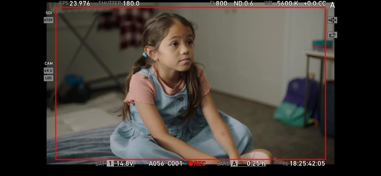 Vanessa Fox in a thoughtful moment on set of Pillow Talk, wearing a denim jumper.
