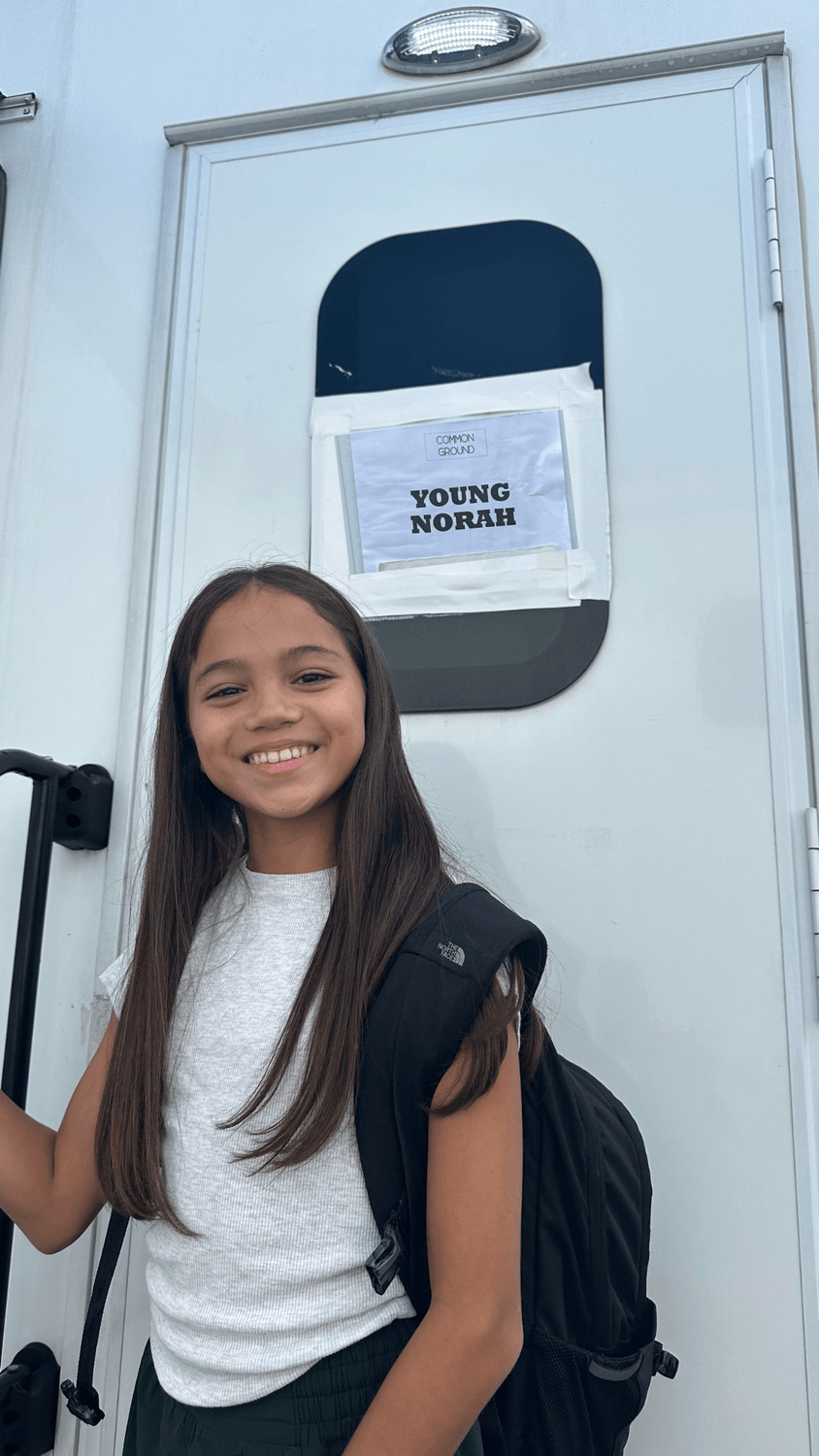 Vanessa Fox smiling outside her trailer marked “Young Norah” on the set of Ginny & Georgia.