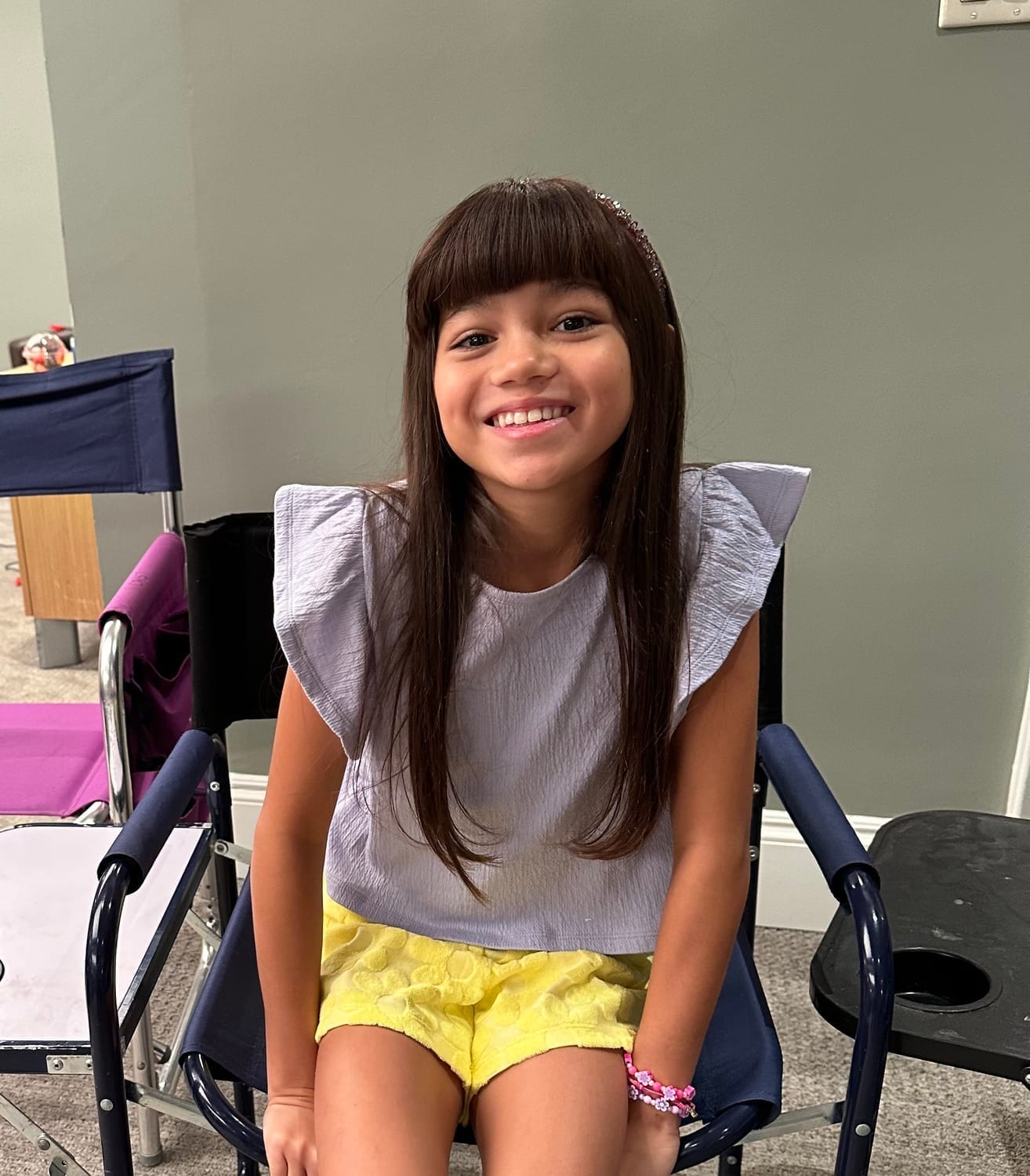 Vanessa Fox smiling on set in her Ginny & Georgia character look.