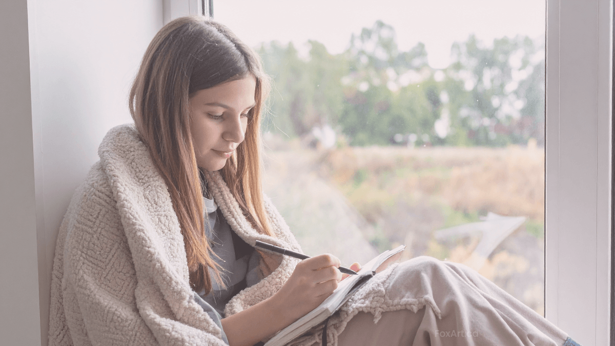 Young creative writing thoughtfully in calm, natural setting.