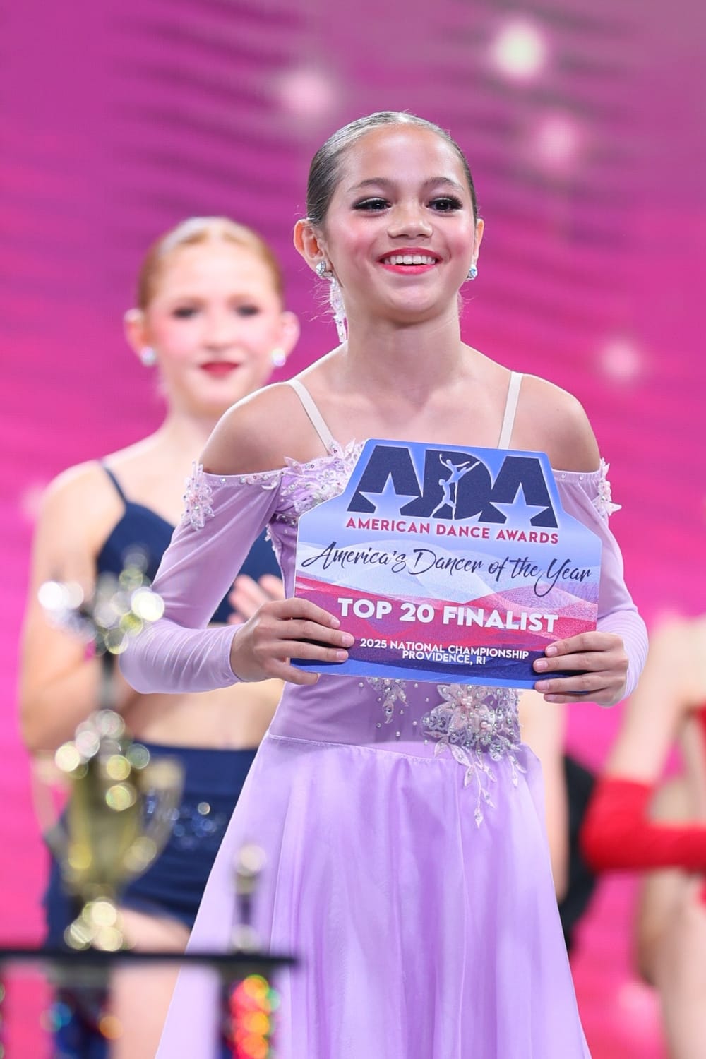 Vanessa Fox holding her American Dance Awards Top 20 Dancer of the Year Finalist certificate.