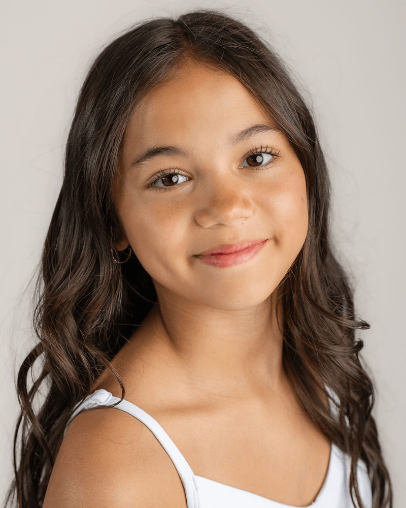 Portrait of Vanessa Fox with long dark hair, wearing a white top.
