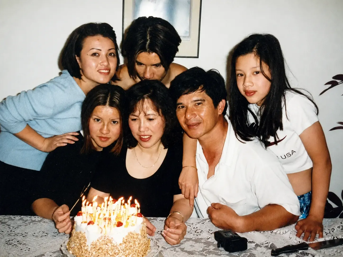 My family gathered around the cake for my mum's birthday, in our younger years