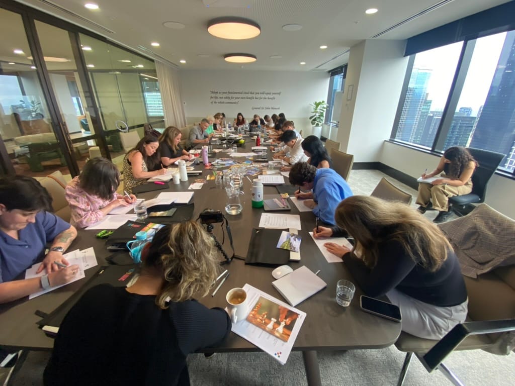 Workshop participants writing individually during a strengths reflection exercise