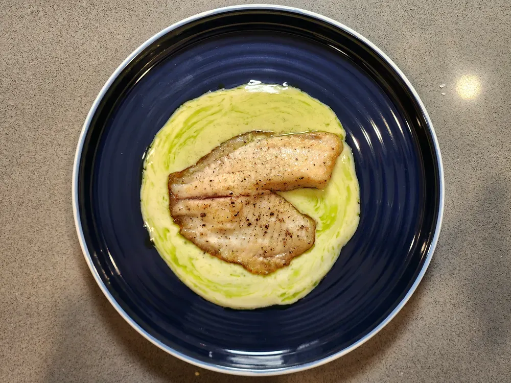 Crispy White Fish in lemon butter sauce with green herb oil
