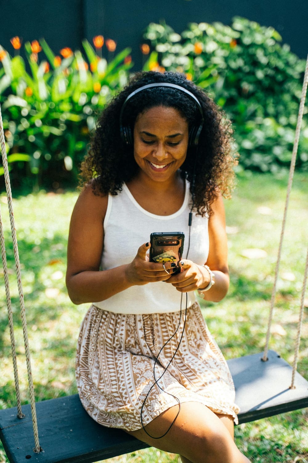 Girl listening to audiobook in the park