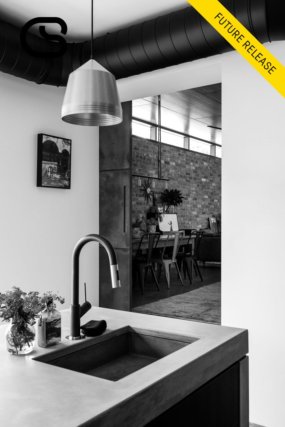 Contemporary kitchen with a concrete island bench, timber cabinetry, copper pendant lights and terracotta floor tiles.