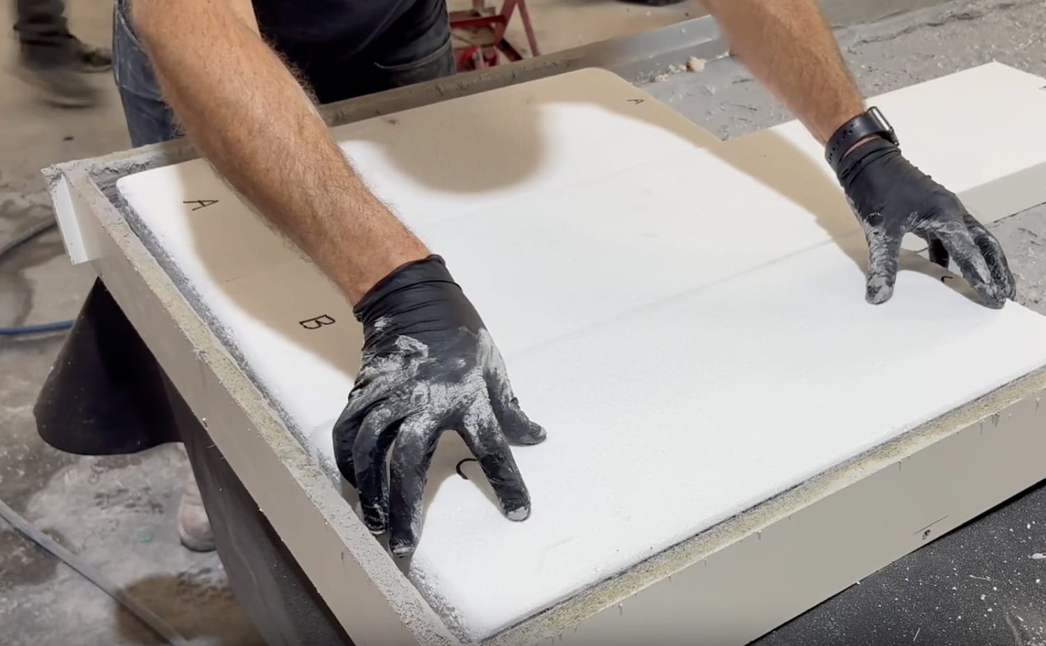 Team member adds foam core to concrete slab