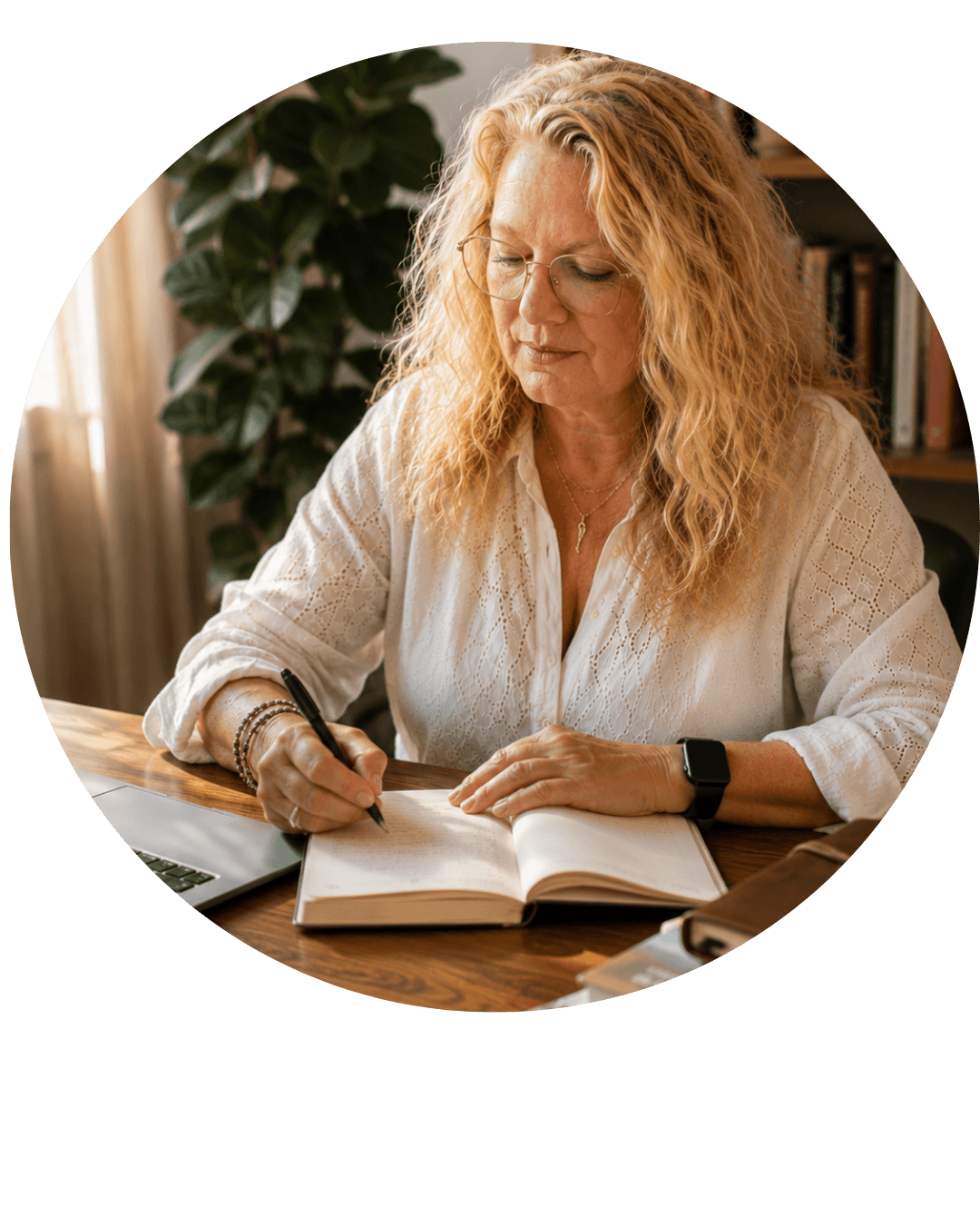 Nicol Heard writing in a journal at her desk, reflecting on her work as an Intuitive Mentor.