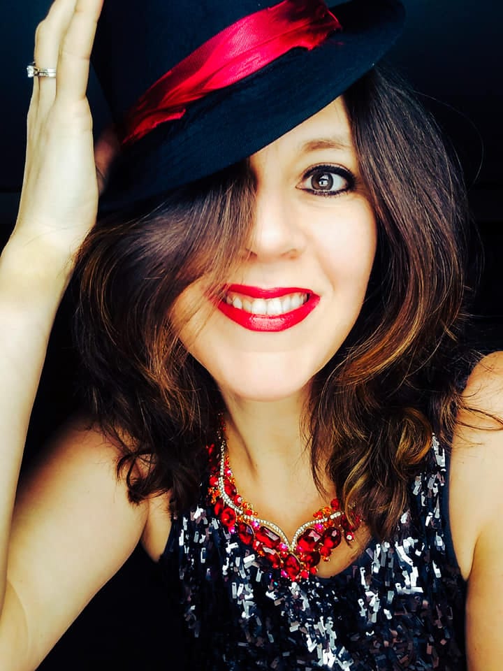 Heather Boers in a red-feathered fedora