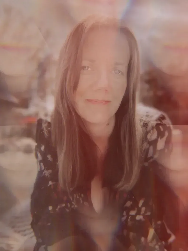 Katie Blount holding space for spiritual exploration, thoughtful portrait with ethereal lighting